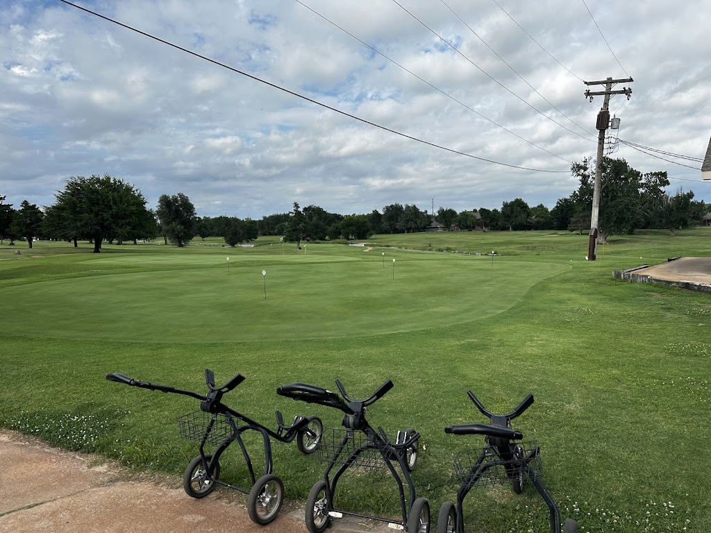 Panoramic view of a lush green golf course at Hidden Creek Family Golf Course. Smooth