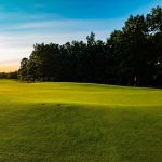 Panoramic view of a lush green golf course at Hidden Creek Golf Club. Smooth