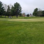 Panoramic view of a lush green golf course at Hidden Creek Golf Course. Smooth