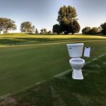 Panoramic view of a lush green golf course at Hidden Hills Golf Course. Smooth