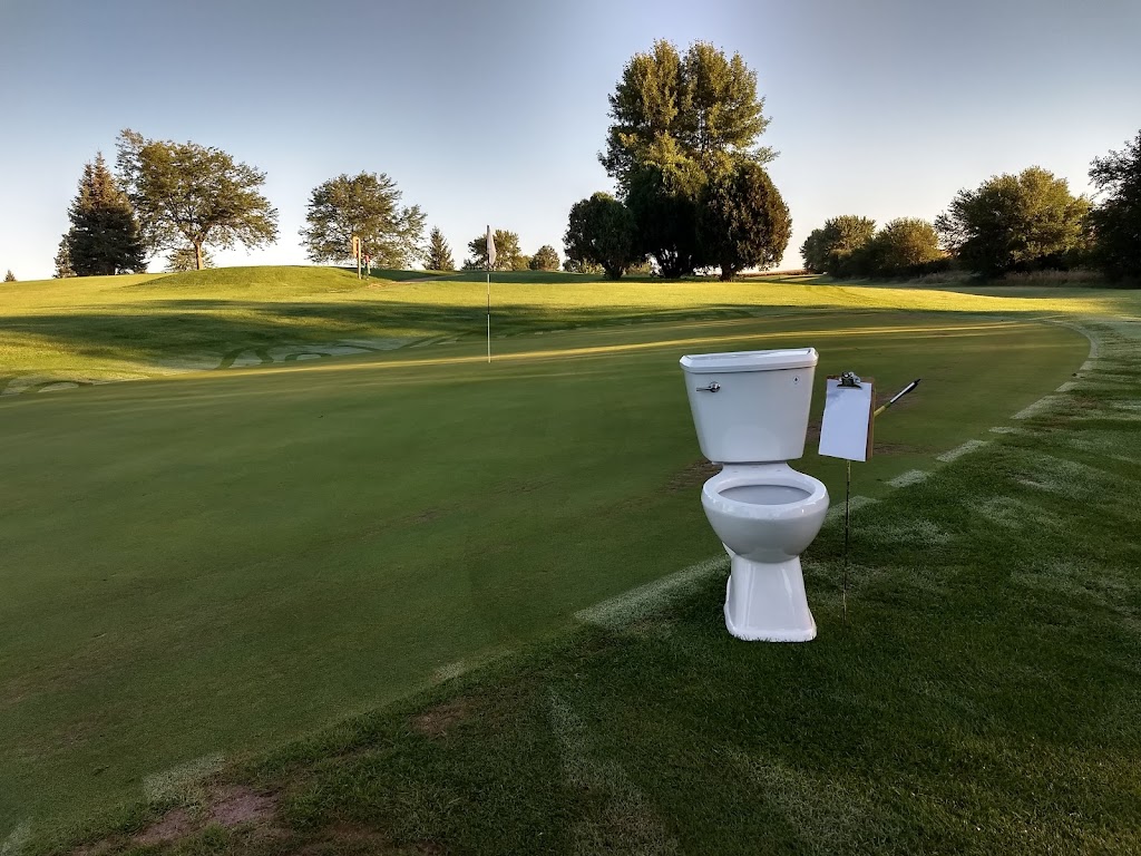 Panoramic view of a lush green golf course at Hidden Hills Golf Course. Smooth