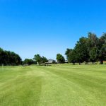 Panoramic view of a lush green golf course at Hidden Trails Golf & Country Club. Smooth