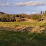 Panoramic view of a lush green golf course at Hidden Valley Golf & Country Club. Smooth