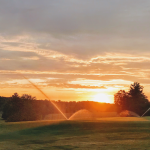 Panoramic view of a lush green golf course at Hidden Valley Golf Course. Smooth