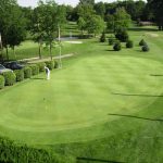 Panoramic view of a lush green golf course at Hidden Valley Golf Course. Smooth