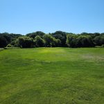 Panoramic view of a lush green golf course at Hidden Valley Golf Course. Smooth
