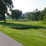 Panoramic view of a lush green golf course at Hidden Valley Golf Links. Smooth