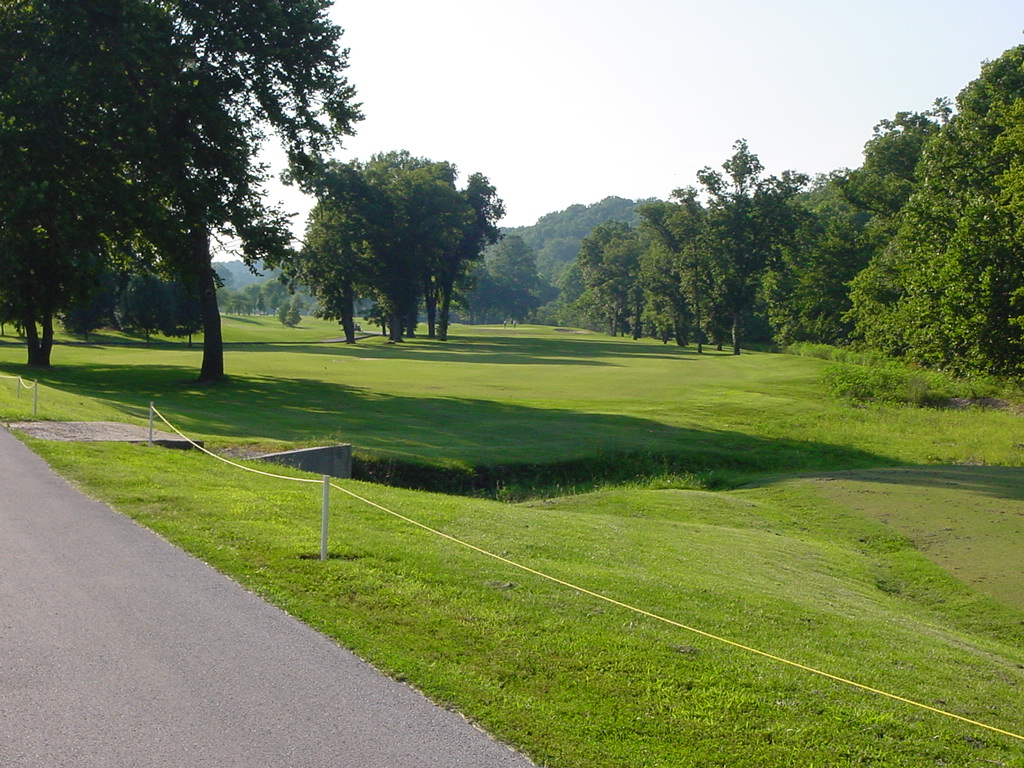 Panoramic view of a lush green golf course at Hidden Valley Golf Links. Smooth