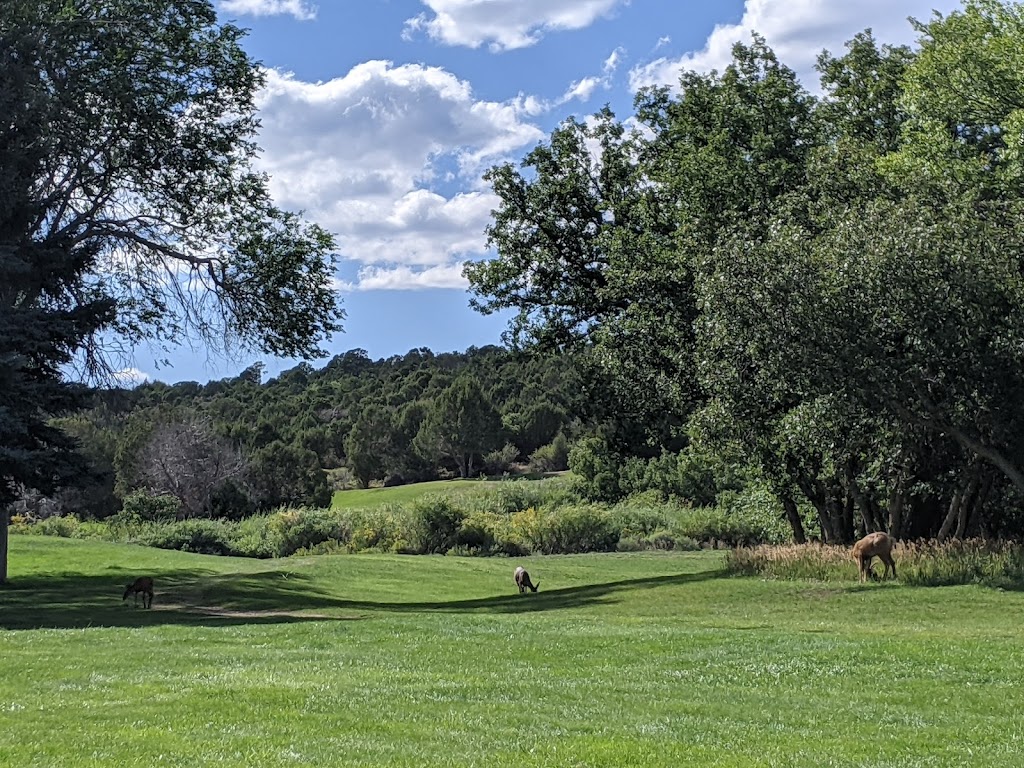 Panoramic view of a lush green golf course at Hideout Golf Course. Smooth
