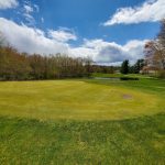Panoramic view of a lush green golf course at High Point Golf Club. Smooth