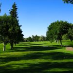 Panoramic view of a lush green golf course at Highland Golf Course. Smooth