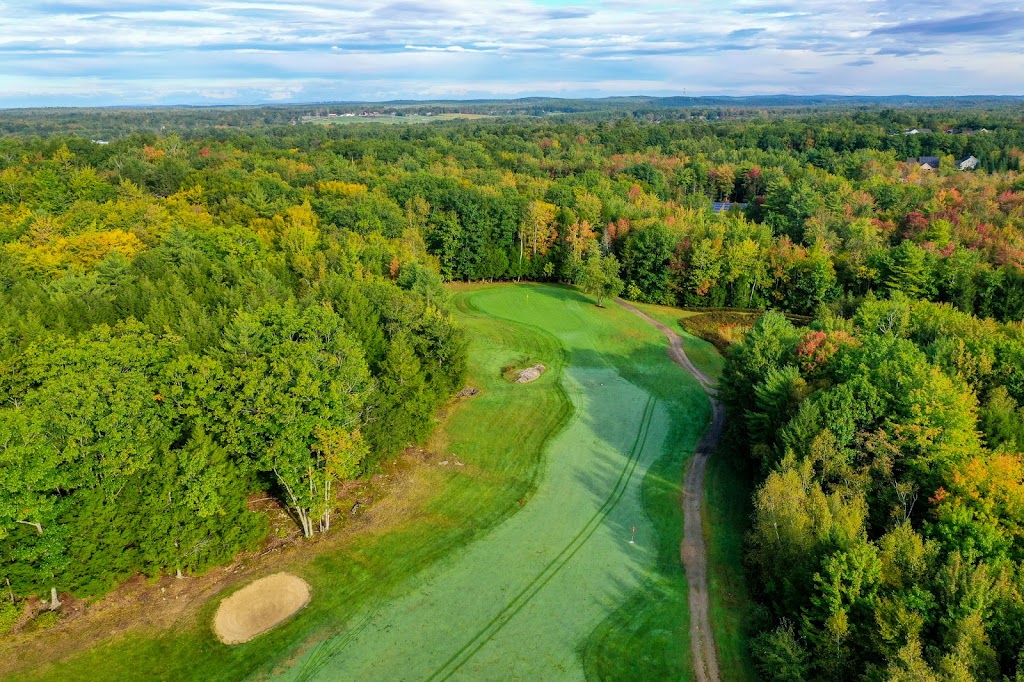 Panoramic view of a lush green golf course at Highland Green Golf Club. Smooth