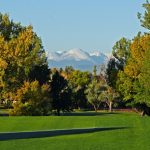 Panoramic view of a lush green golf course at Highland Hills Golf Course. Smooth