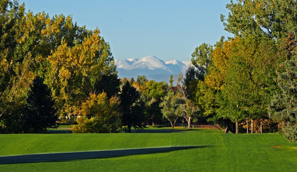 Panoramic view of a lush green golf course at Highland Hills Golf Course. Smooth