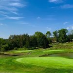 Panoramic view of a lush green golf course at Highland Springs Golf Course Llc. Smooth