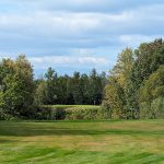 Panoramic view of a lush green golf course at Hillcrest Golf Club. Smooth