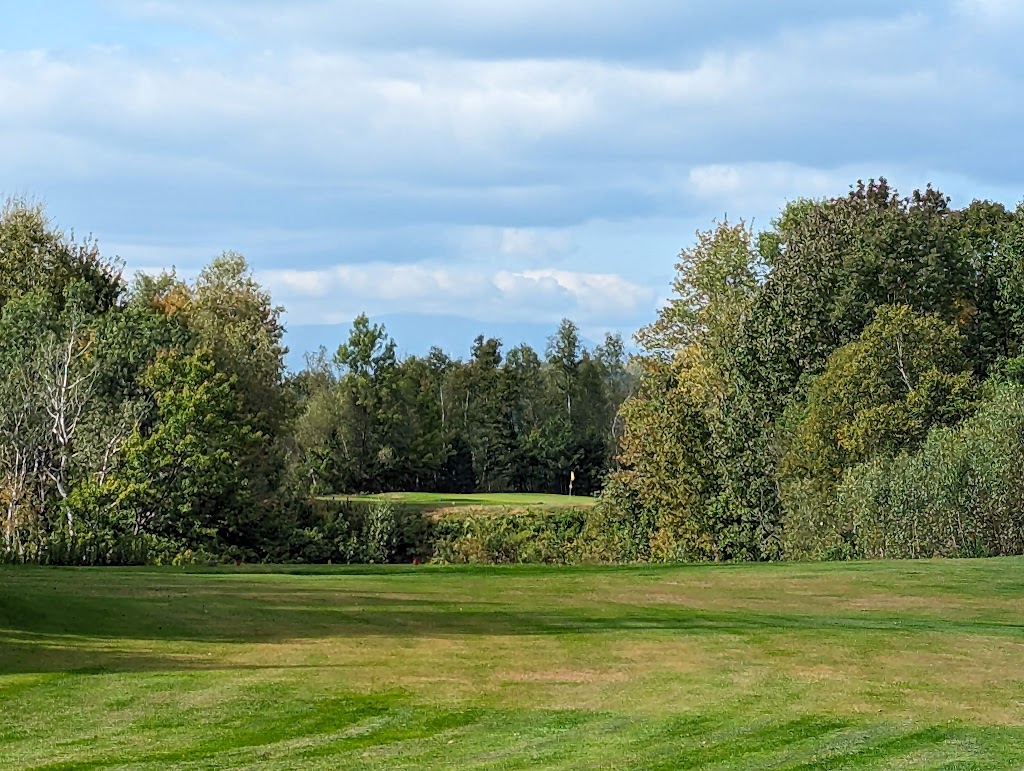 Panoramic view of a lush green golf course at Hillcrest Golf Club. Smooth