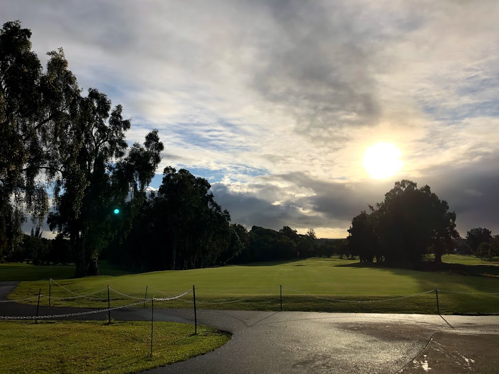 Panoramic view of a lush green golf course at Hilo Municipal Golf Course. Smooth