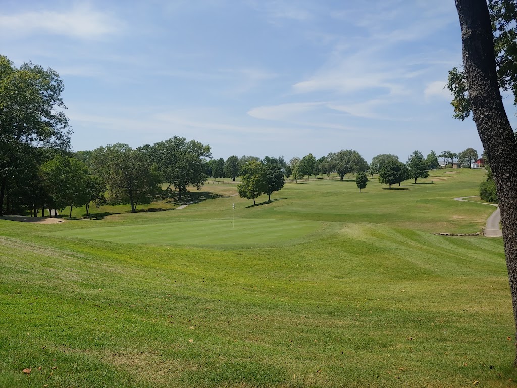 Panoramic view of a lush green golf course at Holiday Hills Golf Club. Smooth