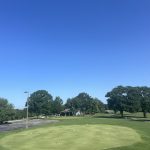 Panoramic view of a lush green golf course at Holiday Island 18 Hole Golf. Smooth