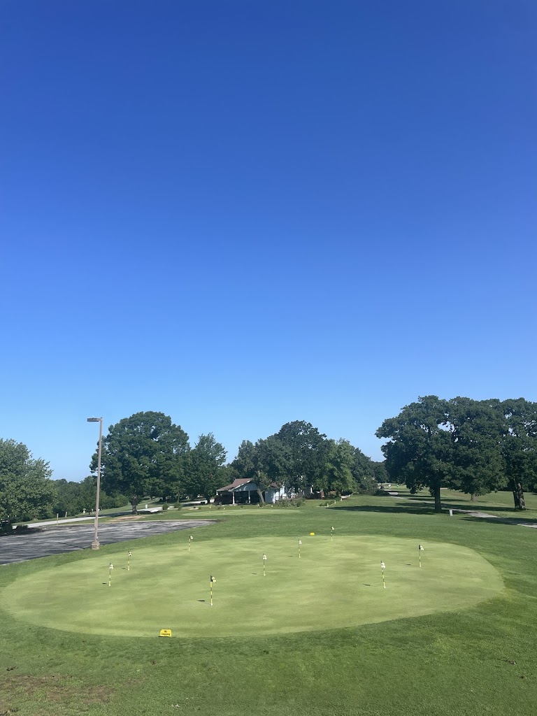 Panoramic view of a lush green golf course at Holiday Island 18 Hole Golf. Smooth