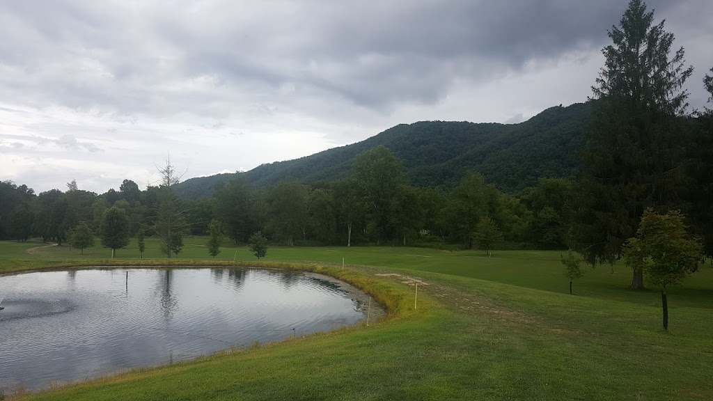 Panoramic view of a lush green golf course at Holly Meadows Golf Course. Smooth