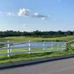 Panoramic view of a lush green golf course at Honky Tonk National Golf. Smooth