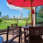 Panoramic view of a lush green golf course at Honolulu Country Club. Smooth