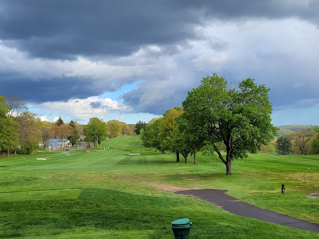 Panoramic view of a lush green golf course at Hop Brook Golf Course. Smooth