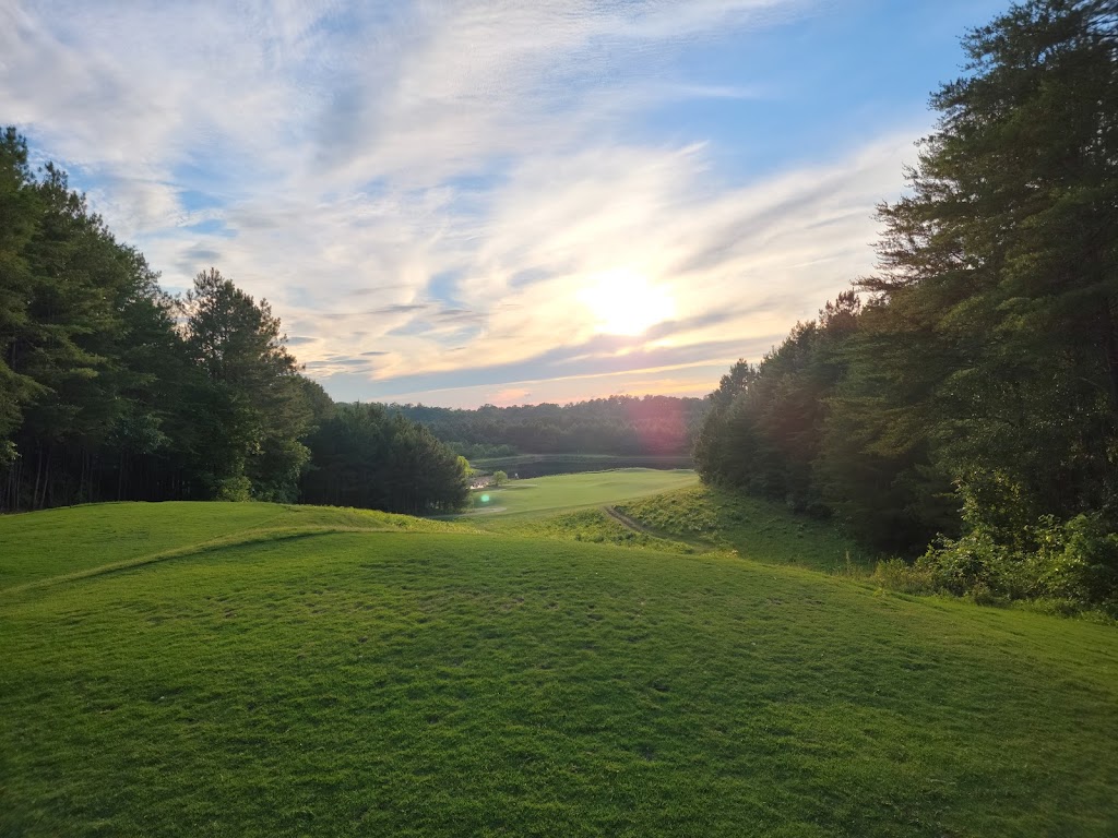 Panoramic view of a lush green golf course at Horse Creek Golf. Smooth