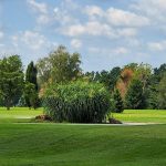 Panoramic view of a lush green golf course at Horton Smith Golf Course. Smooth