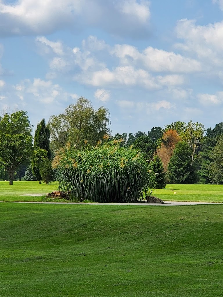 Panoramic view of a lush green golf course at Horton Smith Golf Course. Smooth