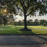 Panoramic view of a lush green golf course at Hot Springs Country Club. Smooth