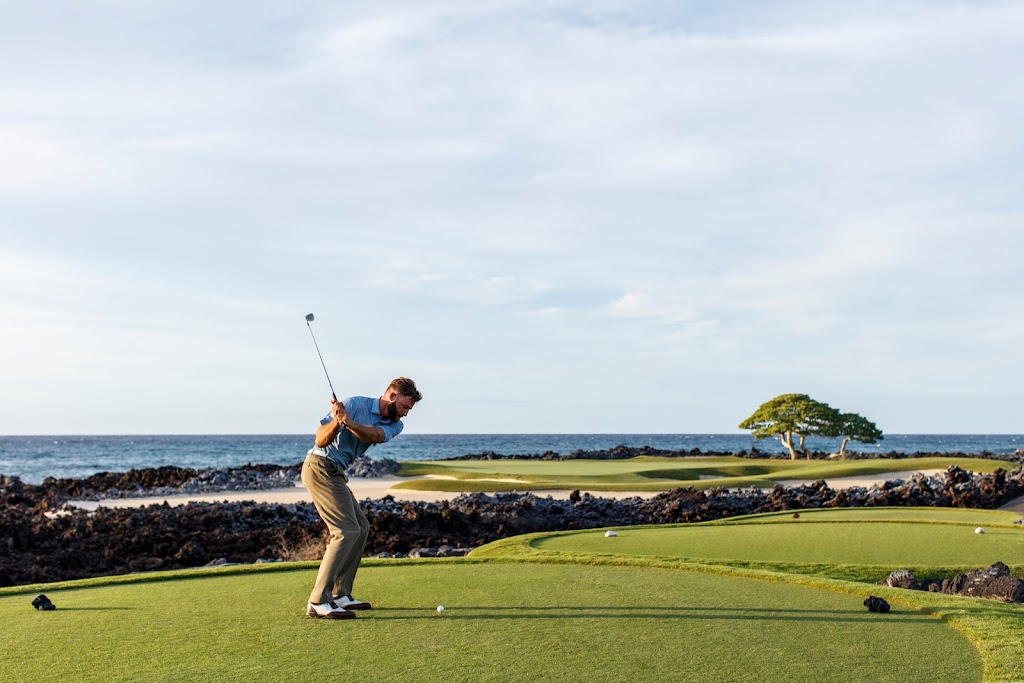 Panoramic view of a lush green golf course at Hualalai Golf Course. Smooth
