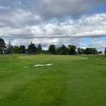 Panoramic view of a lush green golf course at Hubbard Golf Course. Smooth