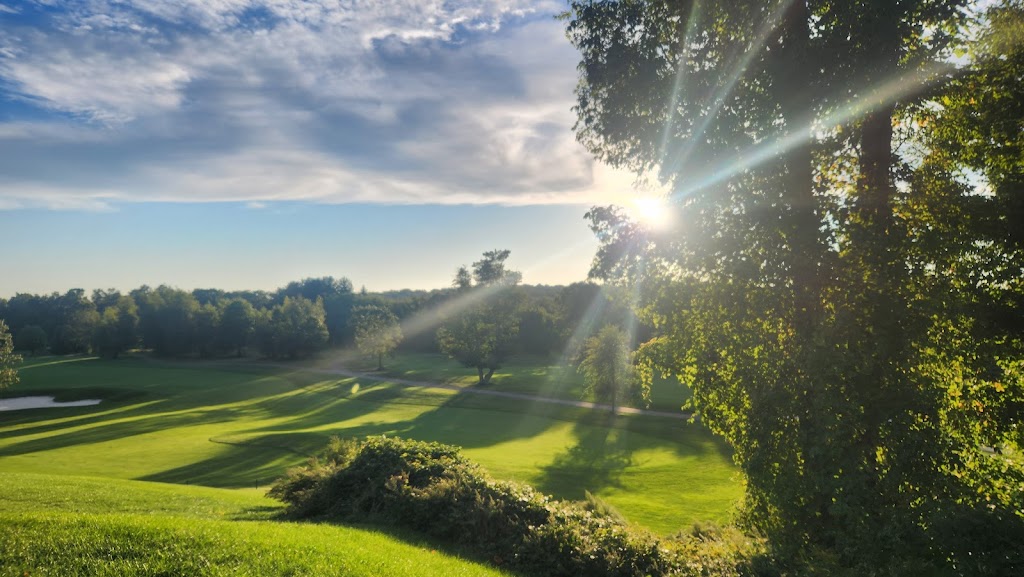 Panoramic view of a lush green golf course at Hudson Hills Golf Course. Smooth