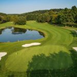 Panoramic view of a lush green golf course at Hunt Valley Country Club. Smooth