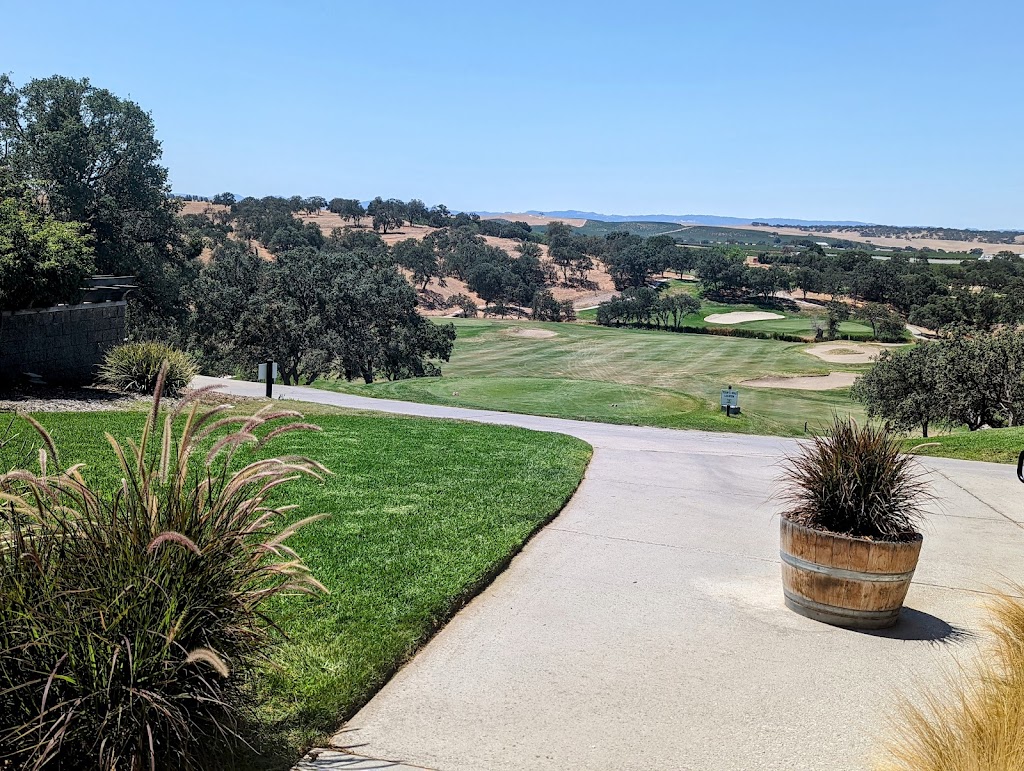 Panoramic view of a lush green golf course at Hunter Ranch Hole 1. Smooth