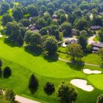 Panoramic view of a lush green golf course at Hunting Creek Country Club. Smooth