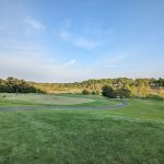 Panoramic view of a lush green golf course at Huntingdon Valley Country Club. Smooth
