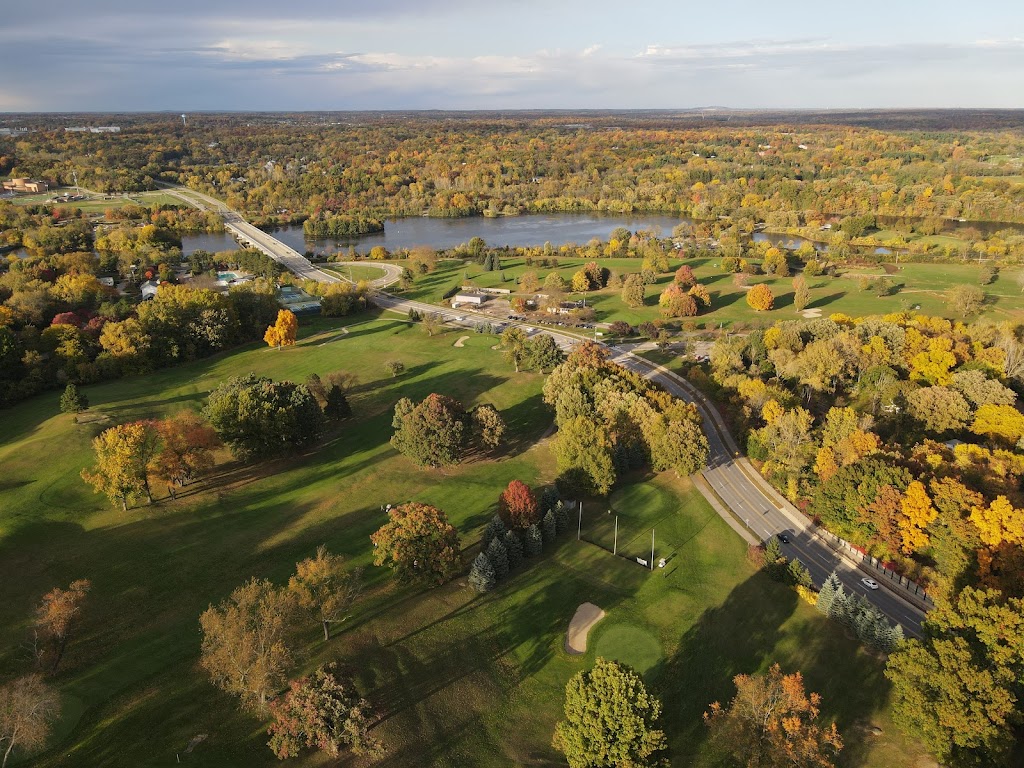 Panoramic view of a lush green golf course at Huron Hills Golf Course. Smooth