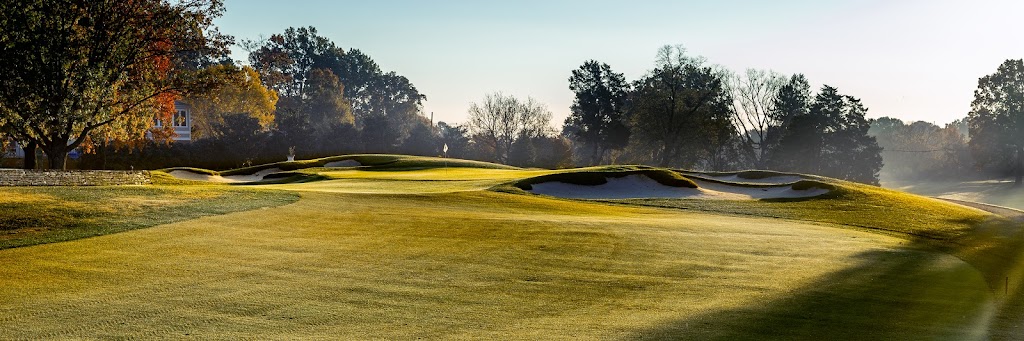 Panoramic view of a lush green golf course at Hurstbourne Country Club. Smooth