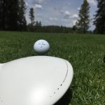 green grass with the flag in the hole.