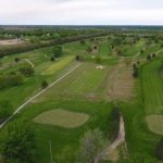 Panoramic view of a lush green golf course at Indian Hill Golf Course. Smooth