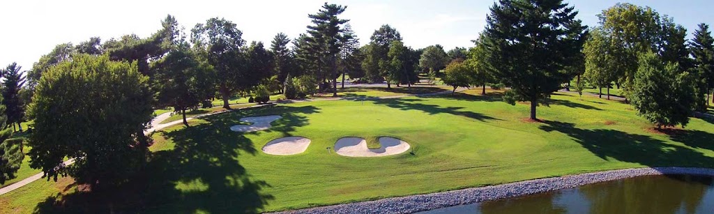 Panoramic view of a lush green golf course at Indian Hills Country Club. Smooth
