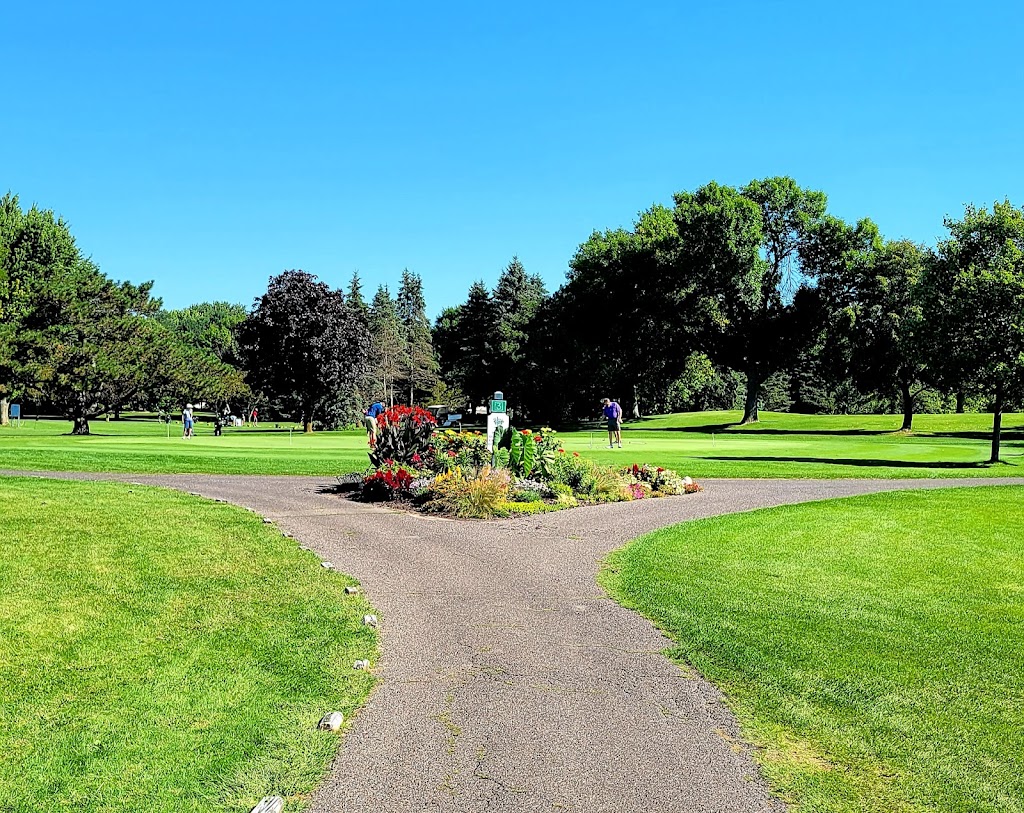 Panoramic view of a lush green golf course at Indian Hills Golf Club. Smooth