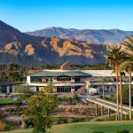 Panoramic view of a lush green golf course at Indian Wells Golf Resort. Smooth