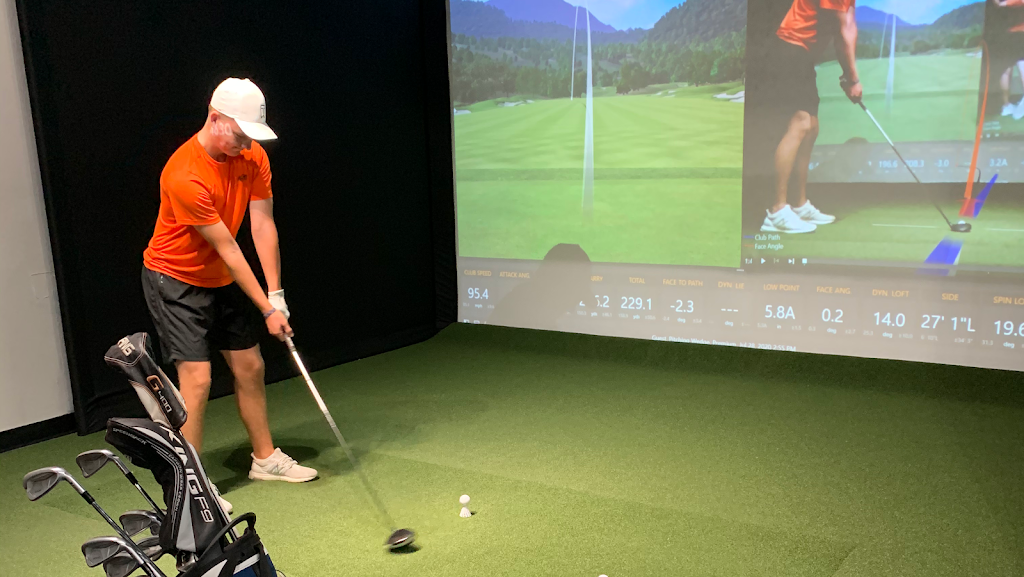 Panoramic view of a lush green golf course at Indoor 18. Smooth