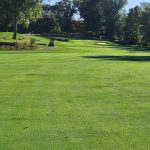 Panoramic view of a lush green golf course at Innis Arden Golf Club. Smooth