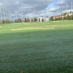 Panoramic view of a lush green golf course at Interbay Golf Center. Smooth